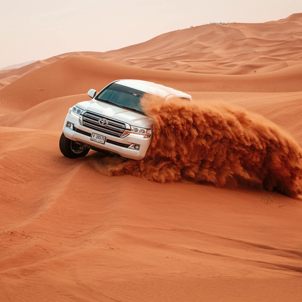pexels photo 4781951 4781951 A Toyota Land Cruiser drives through the vast sandy dunes on an exciting off-road adventure.